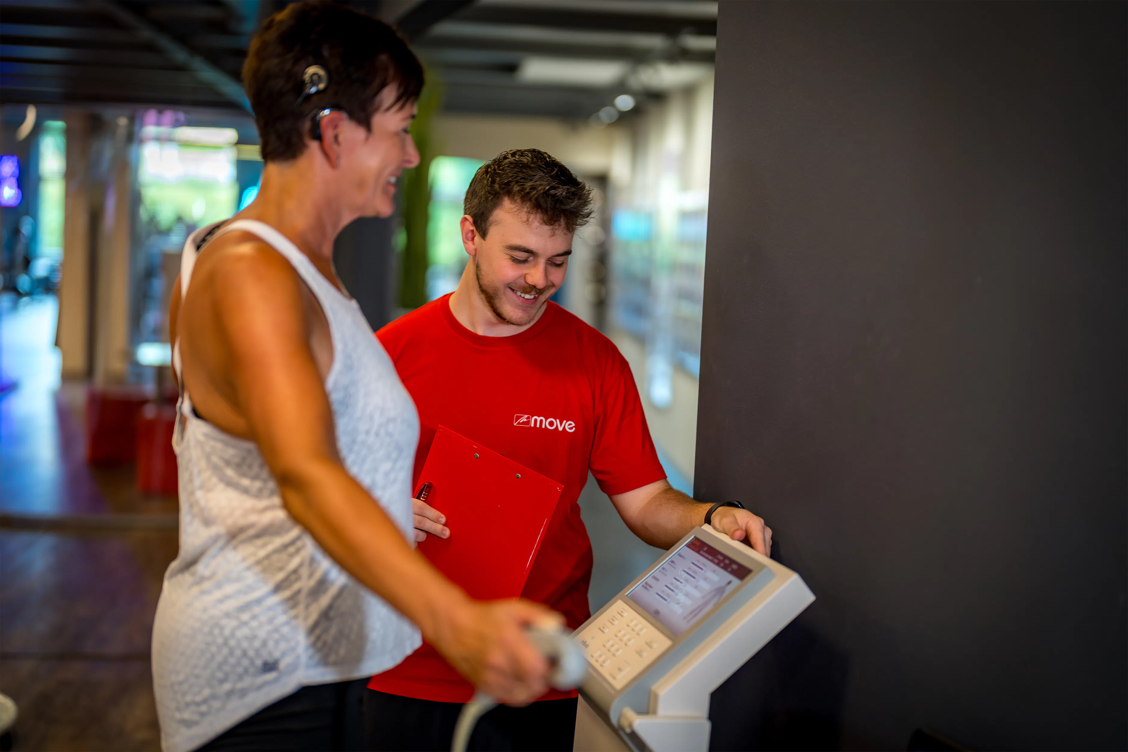 Trainer betreut Mitglied beim Kurzhanteltraining im move Studio