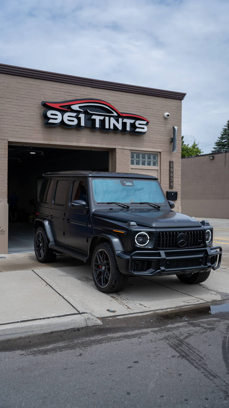 Black G-Wagon with window tint outside the 961 Tints shop in Detroit, MI