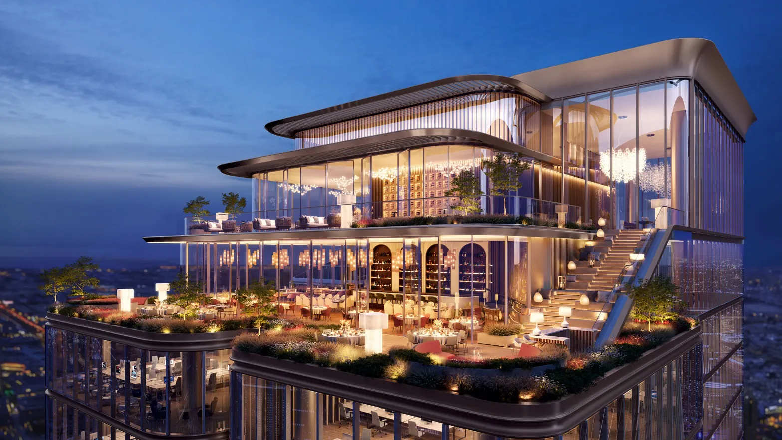 Multi-level rooftop restaurant with glass walls, outdoor seating areas, plants, stairs, and illuminated interior lights at dusk.