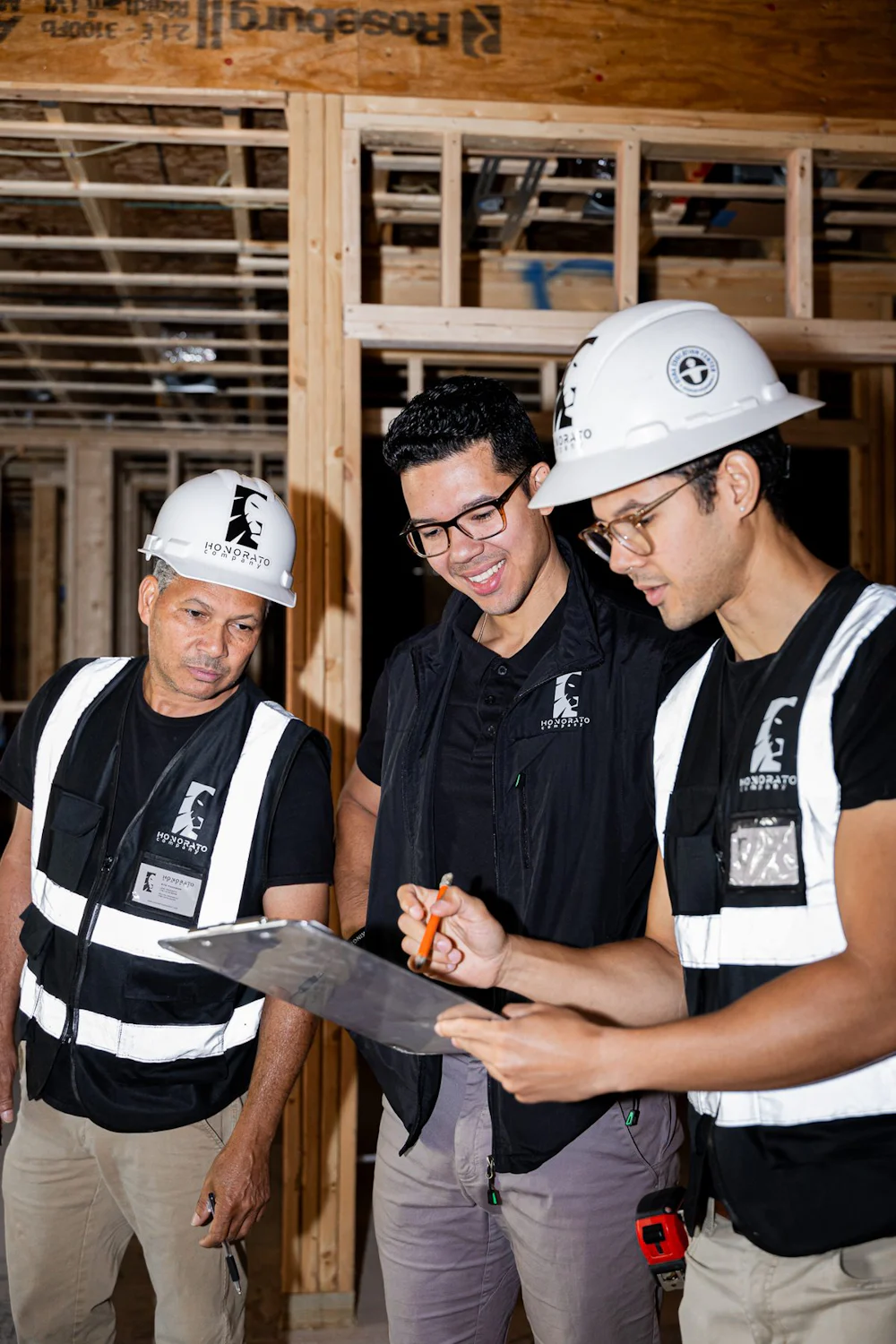 Honorato Company crew reviewing plans on an active job site