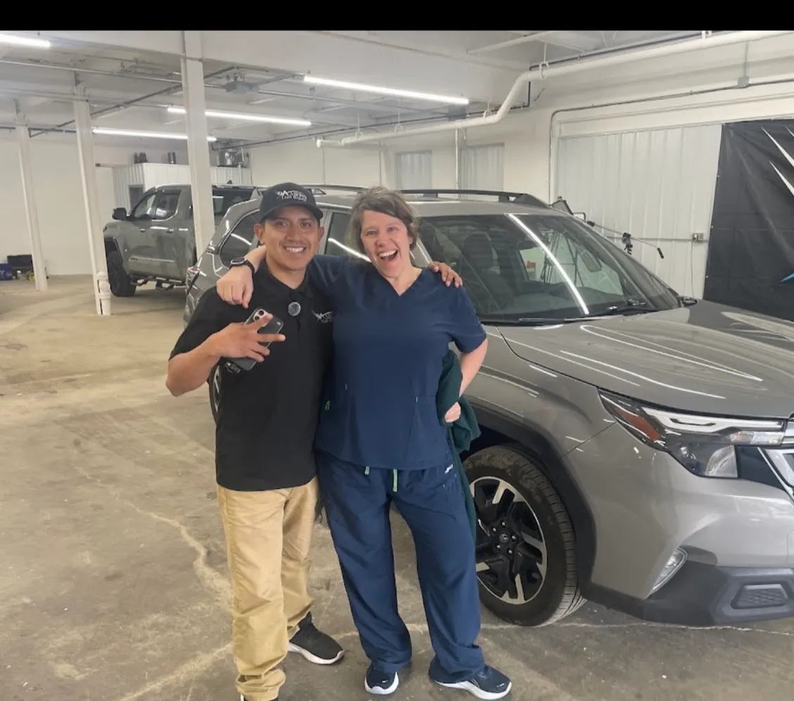 Happy customer hugging repair specialist