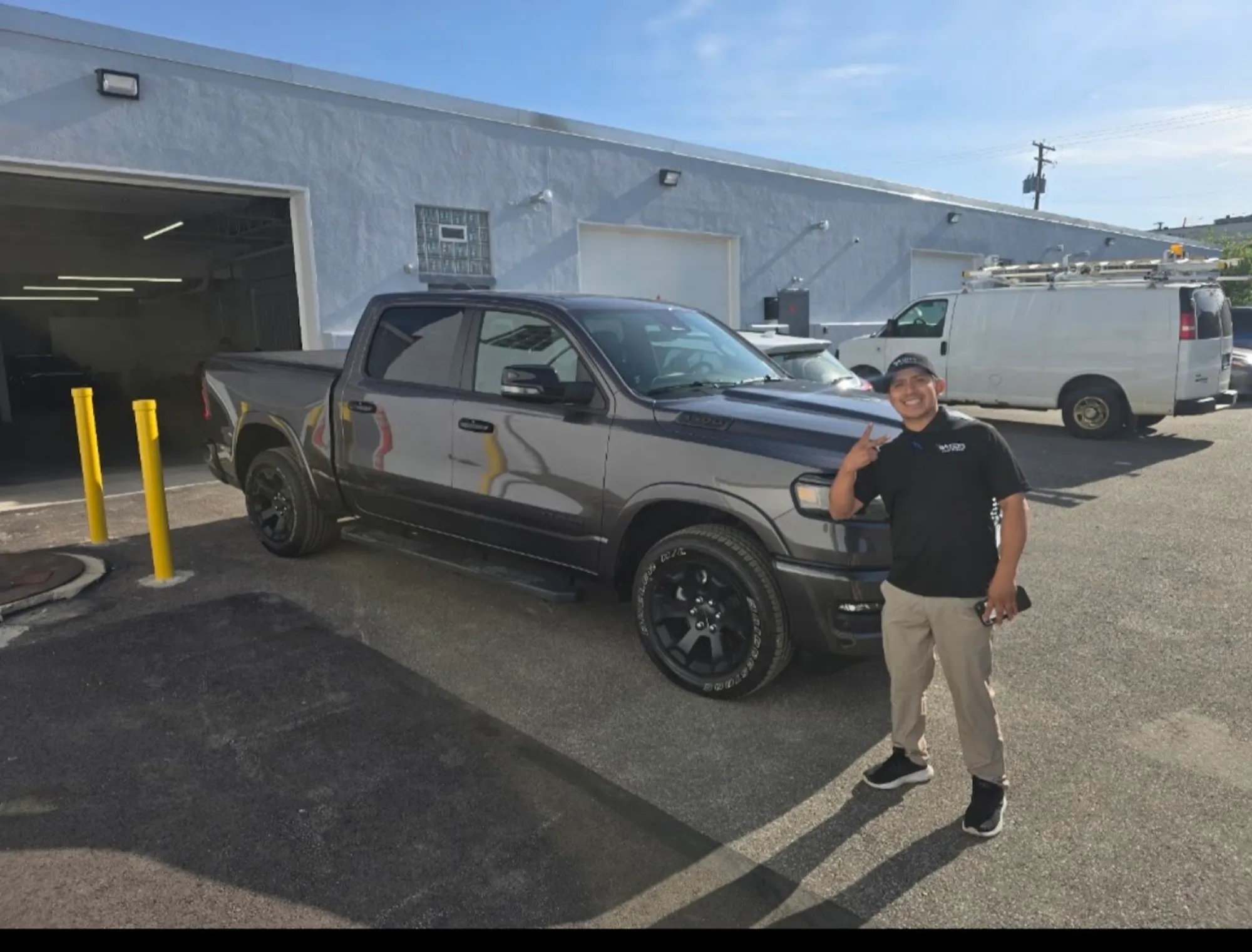 Customer with repaired truck at shop