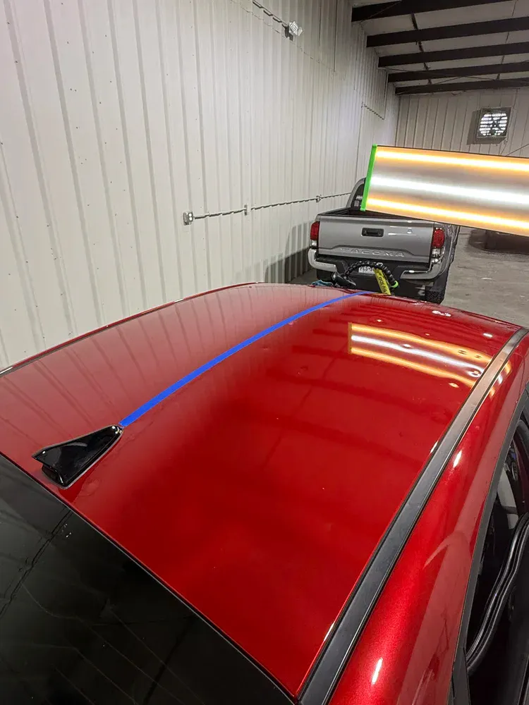 Repaired glossy red car roof