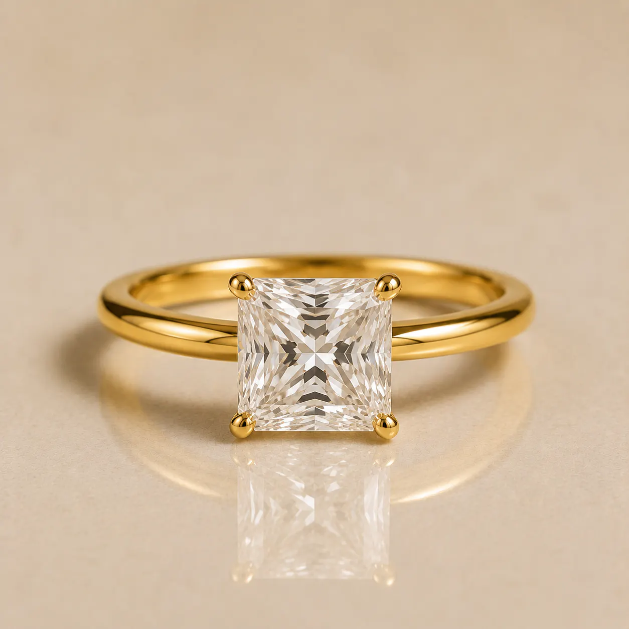 Gold ring with a square-cut clear diamond held by four prongs, reflecting light against a beige background.