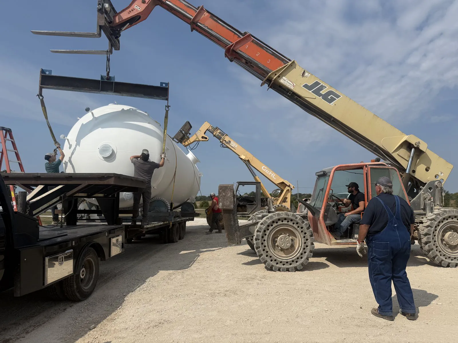 crew loading a large tank