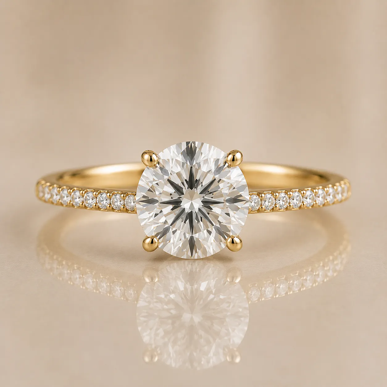 Gold ring with a large round-cut central diamond held by four prongs and smaller diamonds set along the band, reflecting on a beige surface.