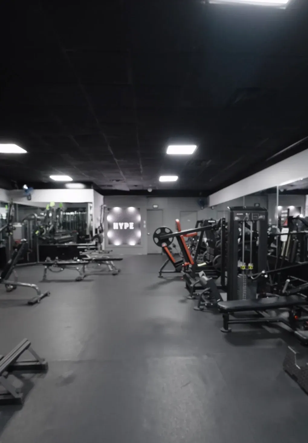 Empty Hype training floor with an illuminated HYPE sign on the back wall