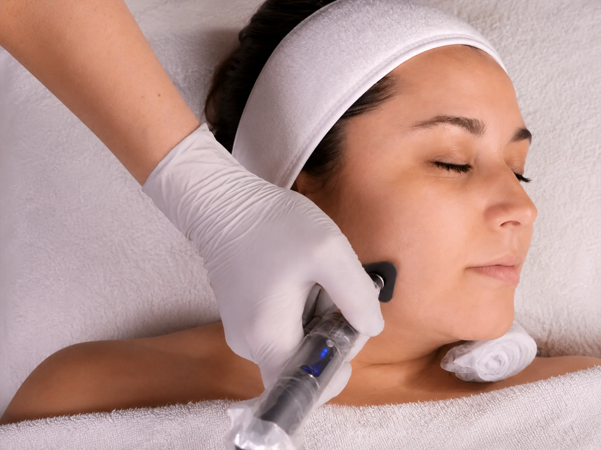 Esthetician giving a microchanneling facial treatment