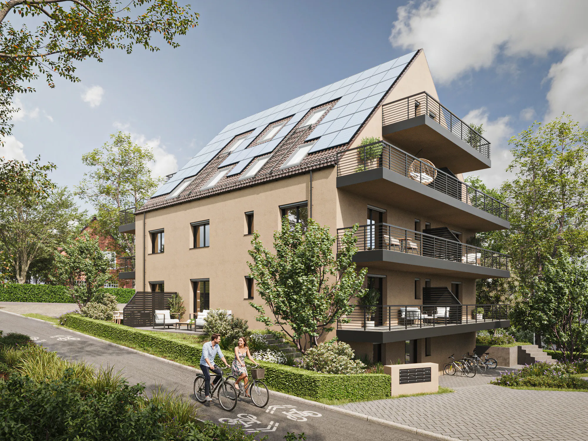 Modern three-story apartment building with solar panels on the roof, balconies, and surrounded by greenery, with two people riding bicycles on a bike path nearby.