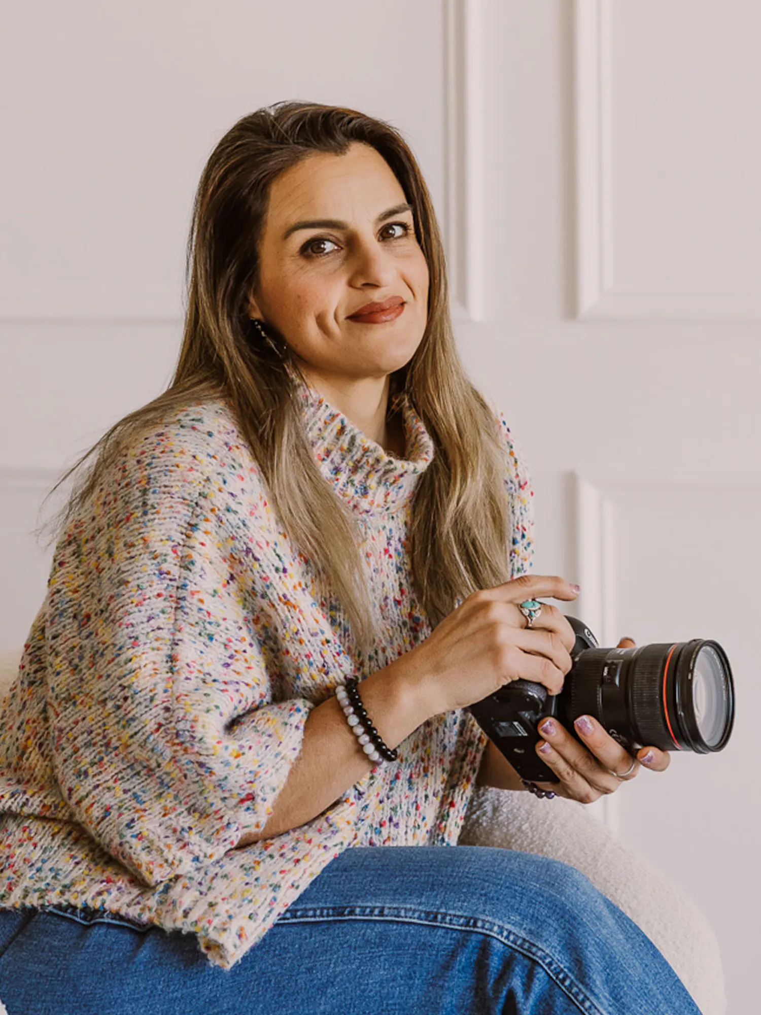 Portrait of Erika holding her camera