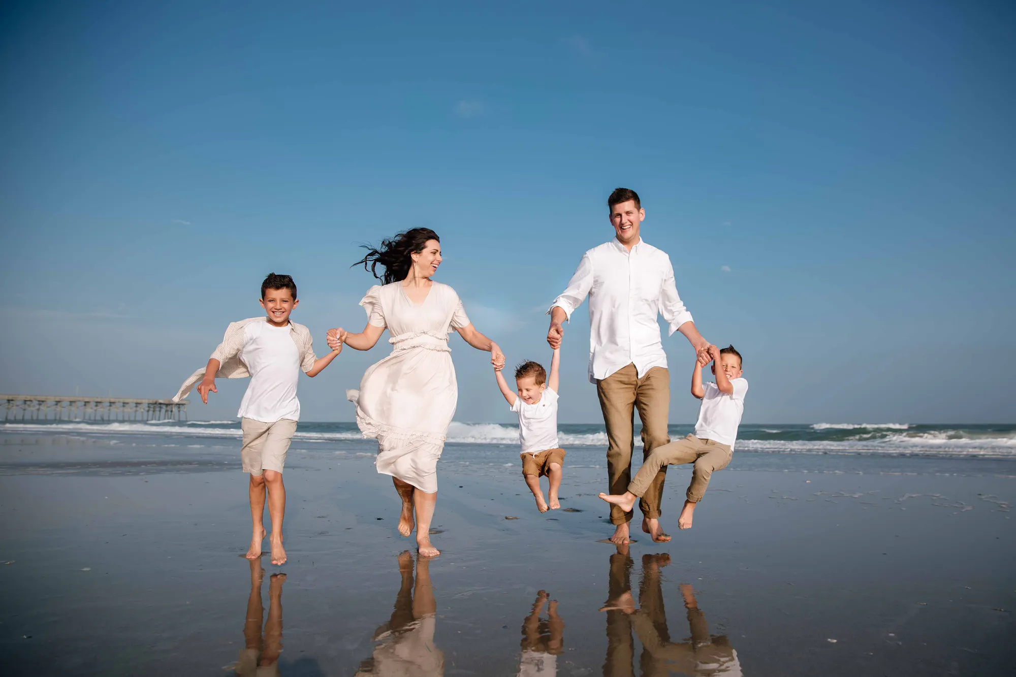 Family running together on the beach