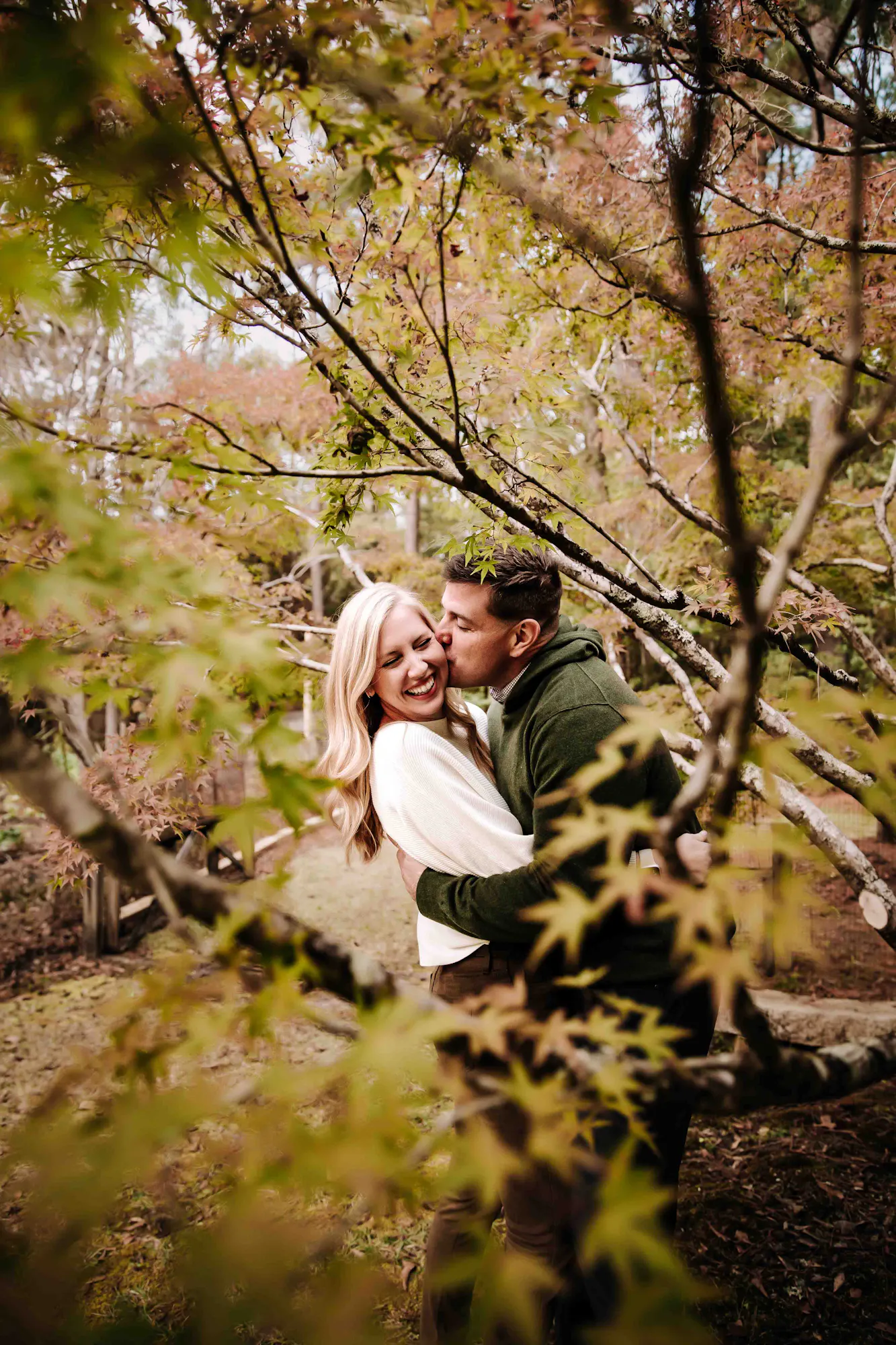 Couple embracing among autumn trees