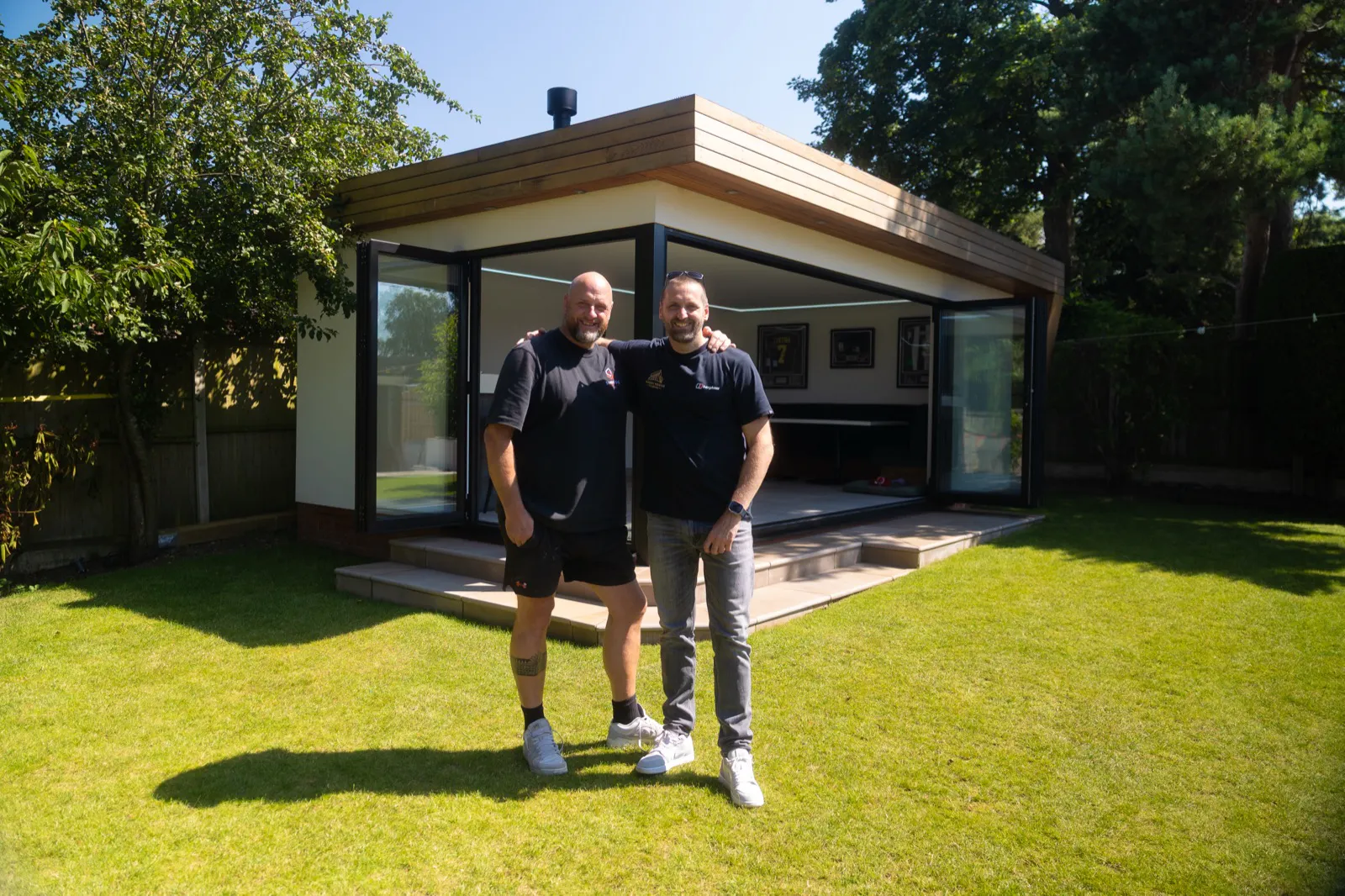 Garden room business owners outside one of their garden rooms