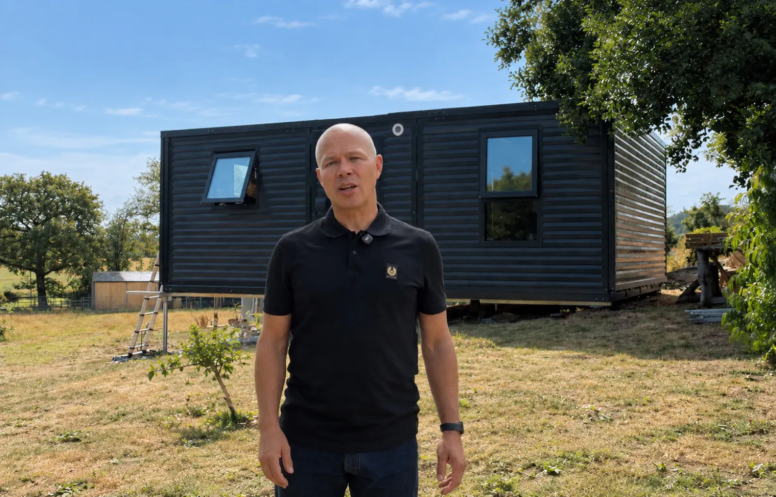 Business owner in front of one of their outdoor buildings
