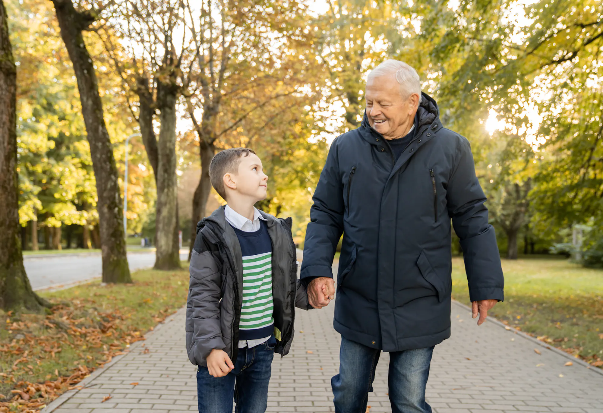 Grandfather walking hand in hand with his grandson