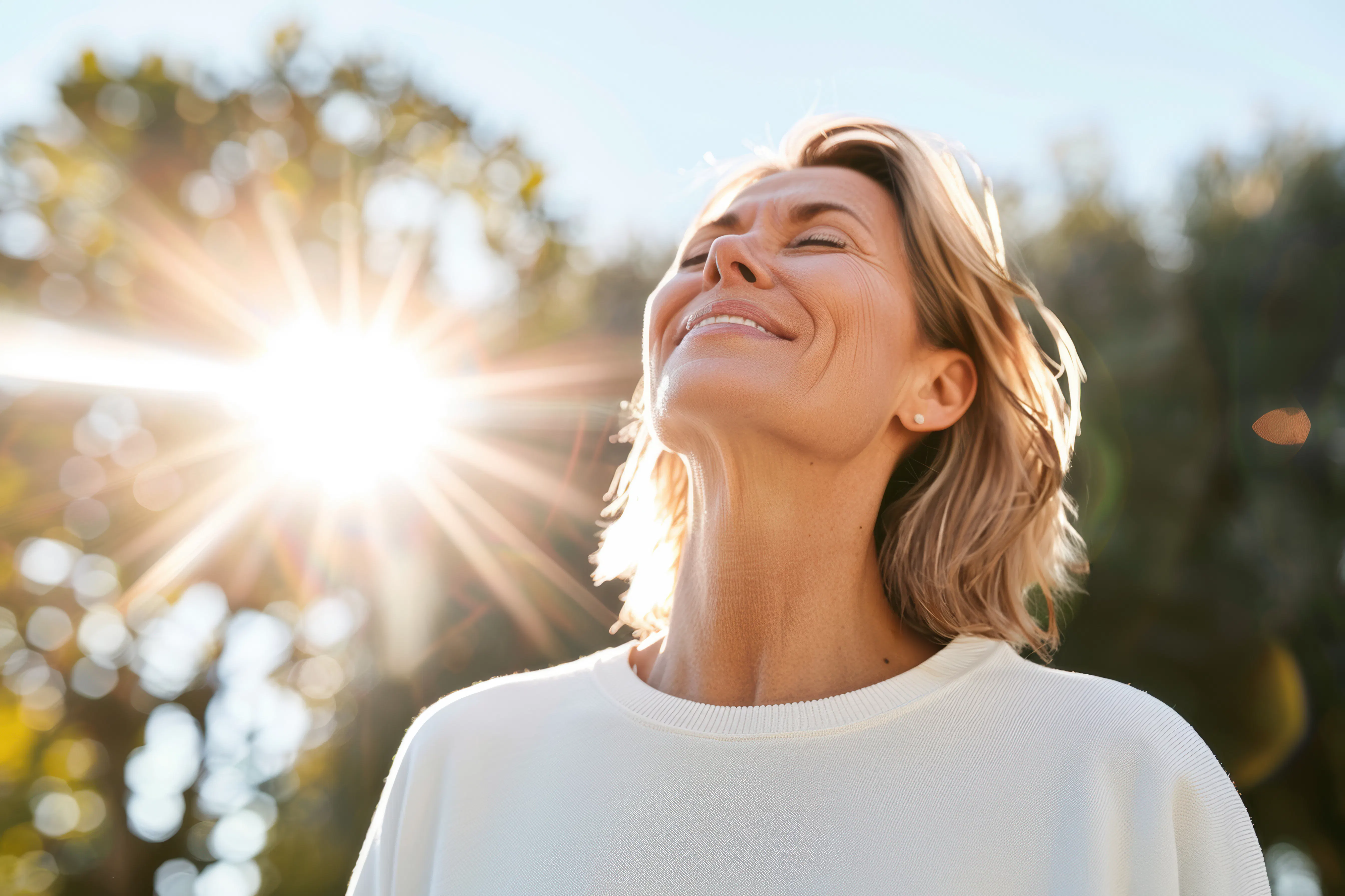 Smiling woman enjoying the sunshine outdoors