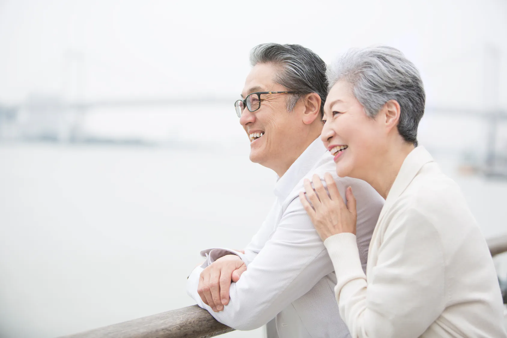 Smiling retired couple looking out over the water